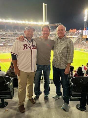 Omega leadership team David Elkins, Fletch Leonard, and Keehn Berry at Truist Park during an Atlanta Braves game
